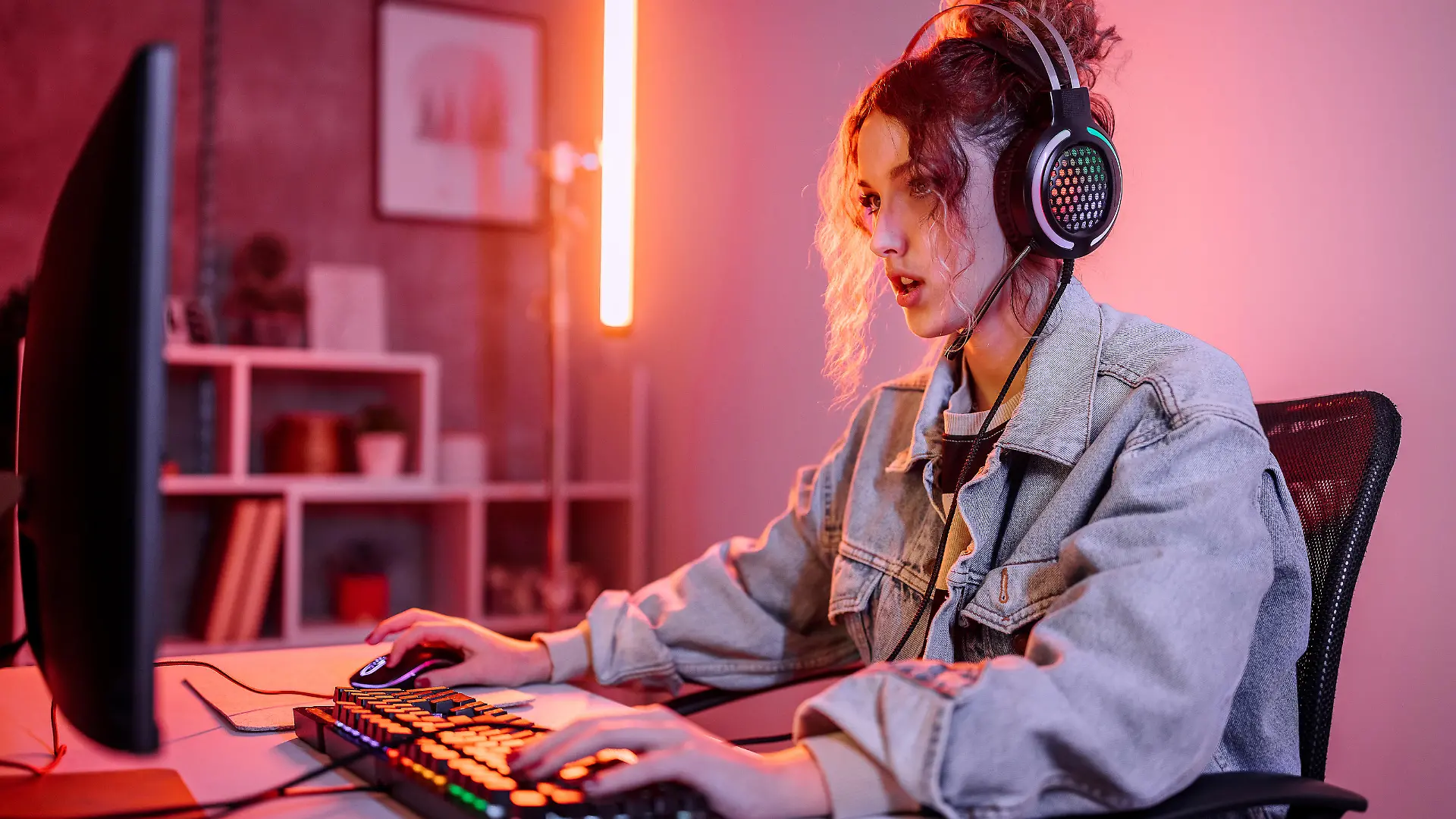 Young woman live streaming while playing multiplayer online game in living room at home