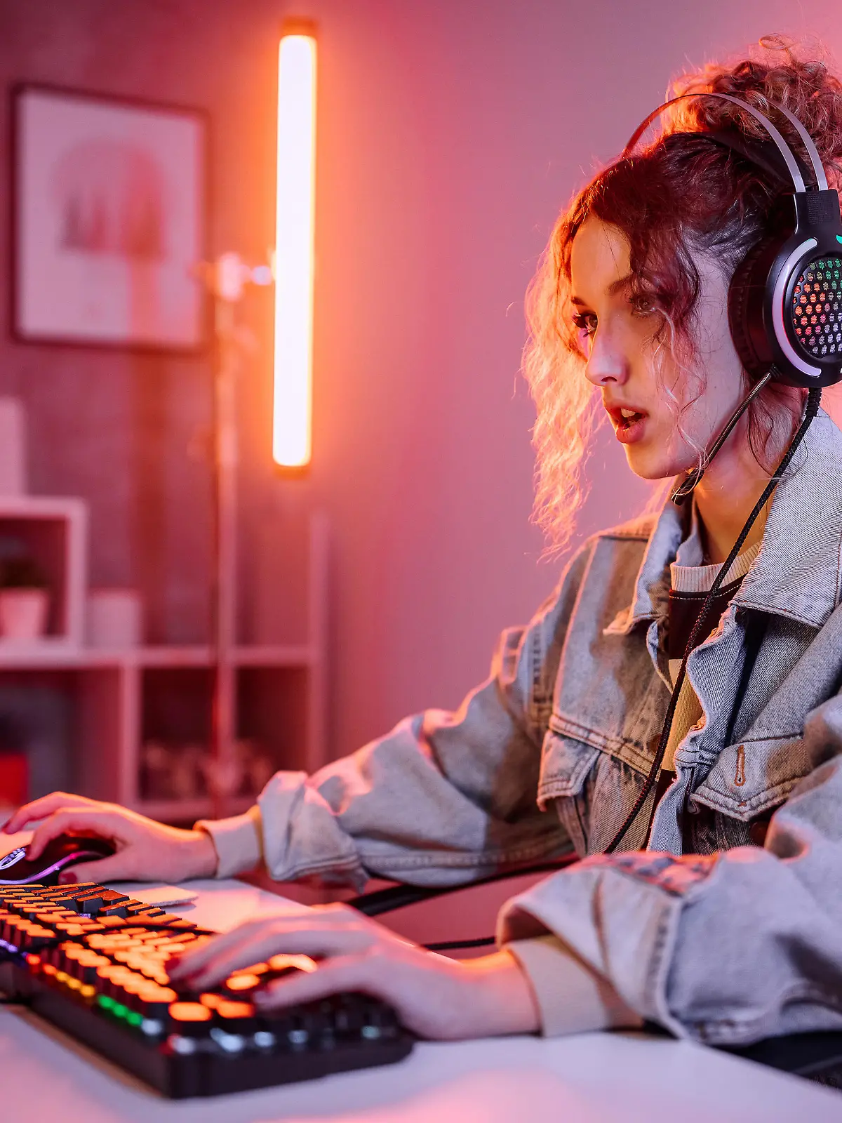 Young woman live streaming while playing multiplayer online game in living room at home