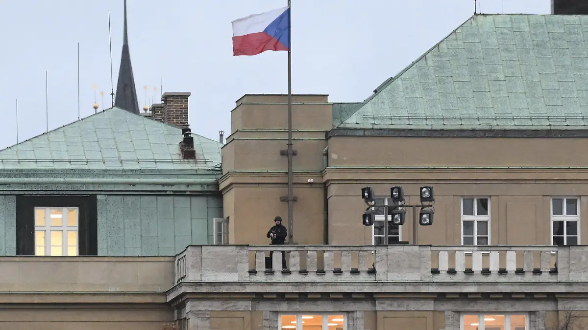 21.12.2023, Tschechien, Prag: Ein Polizist auf dem Dach des Gebäudes der Philosophischen Fakultät. An einer Hochschule in der Prager Innenstadt sollen Schüsse gefallen sein. Foto: Deml Ondøej/CTK/dpa +++ dpa-Bildfunk +++