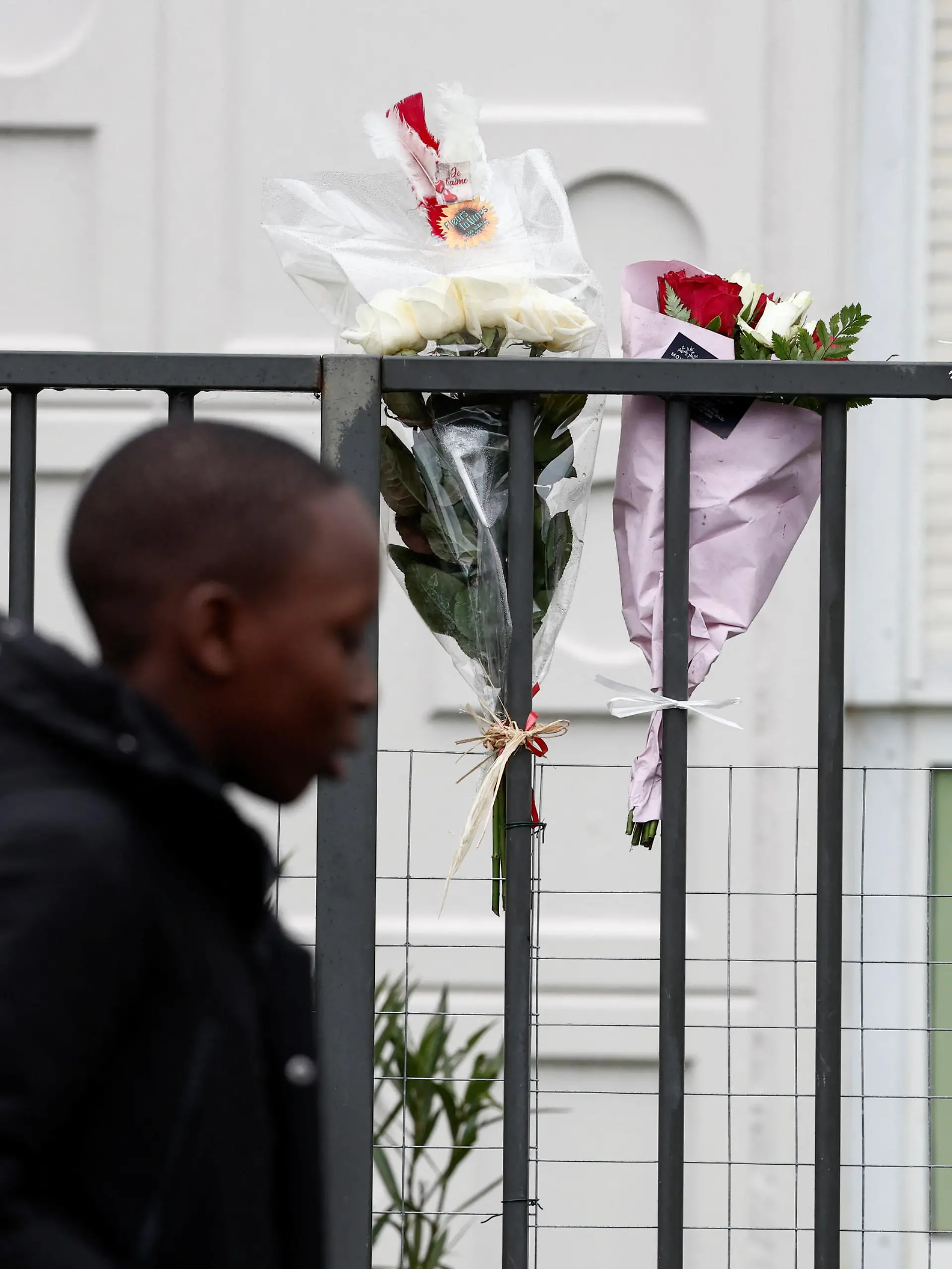 Bunches of flowers are placed on the fence, in front of the ground floor flat where the bodies of a woman and her four children where discovered, in Meaux, northeast of Paris, France, December 26, 2023. REUTERS/Benoit Tessier