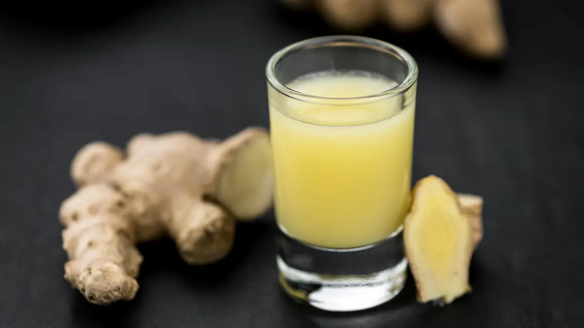 Portion of fresh Ginger Juice (selective focus; close-up shot)