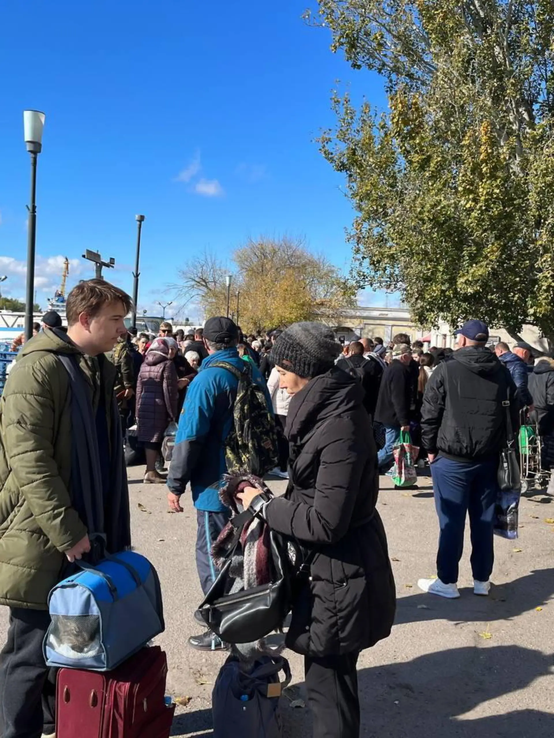 RUSSIA, KHERSON - OCTOBER 19, 2022: People gather at the port of Kherson for evacuation. Kherson Region authorities have started organized evacuation of residents of the right bank of the Dnieper River from the port of Kherson. On October 18, Kherson Region Acting Governor Vladimir Saldo announced the evacuation of civilians to the left bank of the Dnieper River due to a threat of flooding that could happen in case the Ukrainian Army hit the Kakhovka Hydroelectric Power Plant. Dmitry Marmyshev/TASS / action press