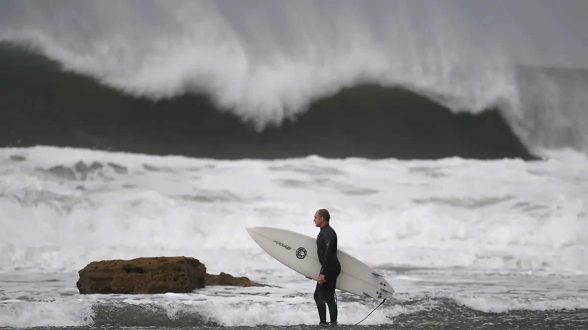 29.05.2019, Australien, Melbourne: Ein Surfer macht sich bereit, um am Winkipop in der Nähe von Bells Beach im südöstlichen Bundesstaat Victoria zu surfen. Eine Kaltfront sorgt für große Wellen, Wind und Regen. Foto: Julian Smith/AAP/dpa +++ dpa-Bildfunk +++