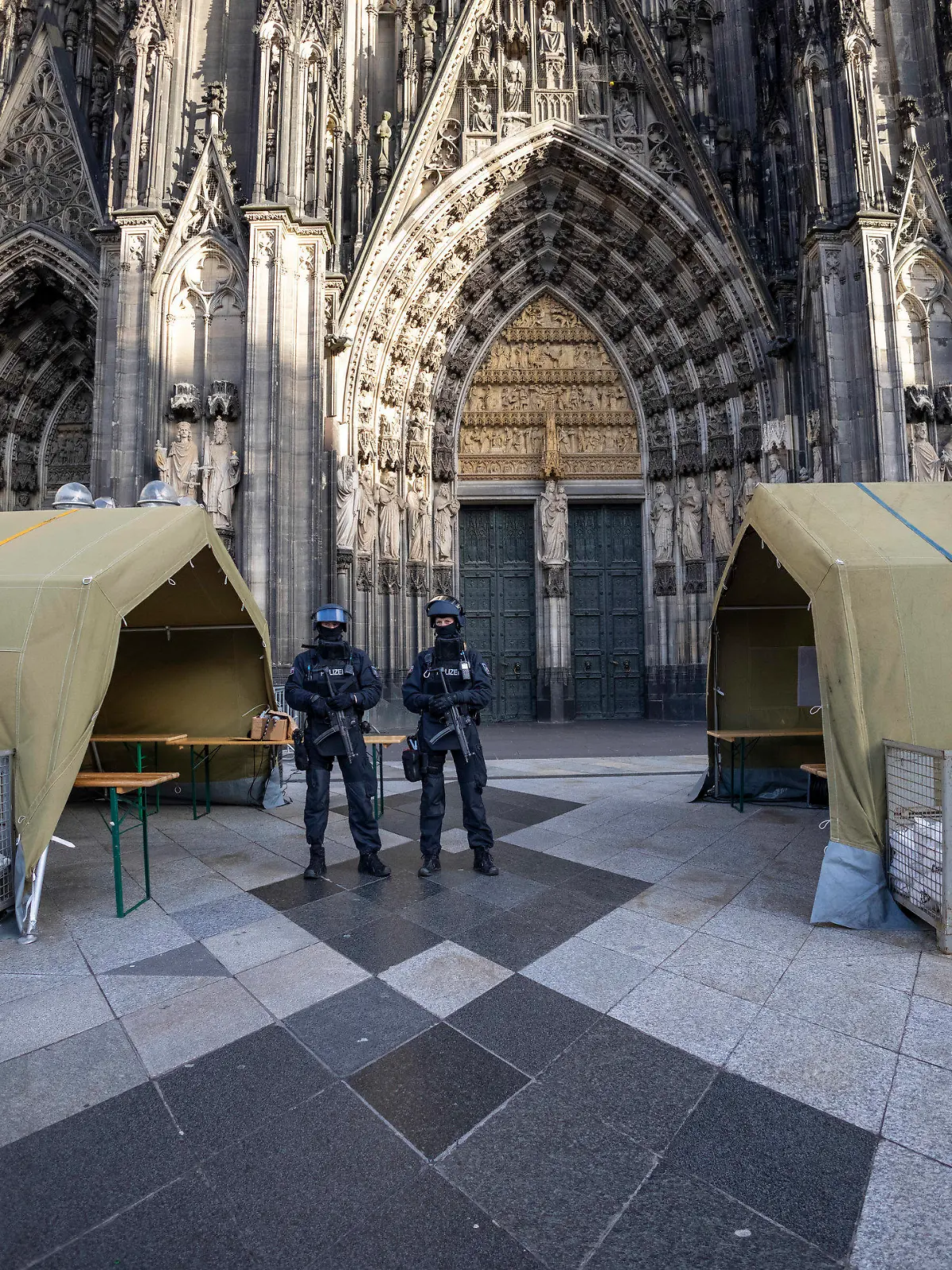 dpatopbilder - 31.12.2023, Nordrhein-Westfalen, Köln: Vor dem Pontifikalamt im Kölner Dom zum Jahresabschluss mit Kardinal Woelki wird das Domumfeld von Einsatzkräften der Polizei mit Maschinenpistolen stark bewacht. Foto: Thomas Banneyer/dpa +++ dpa-Bildfunk +++