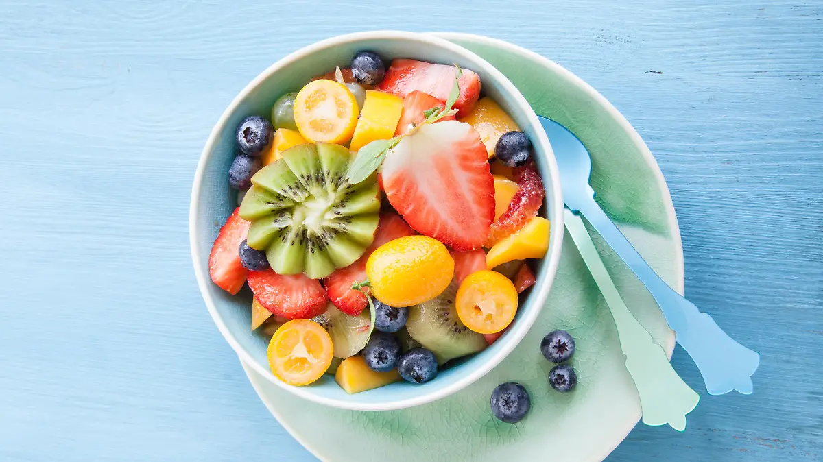 Ceramic cup with salad made from fresh fruits