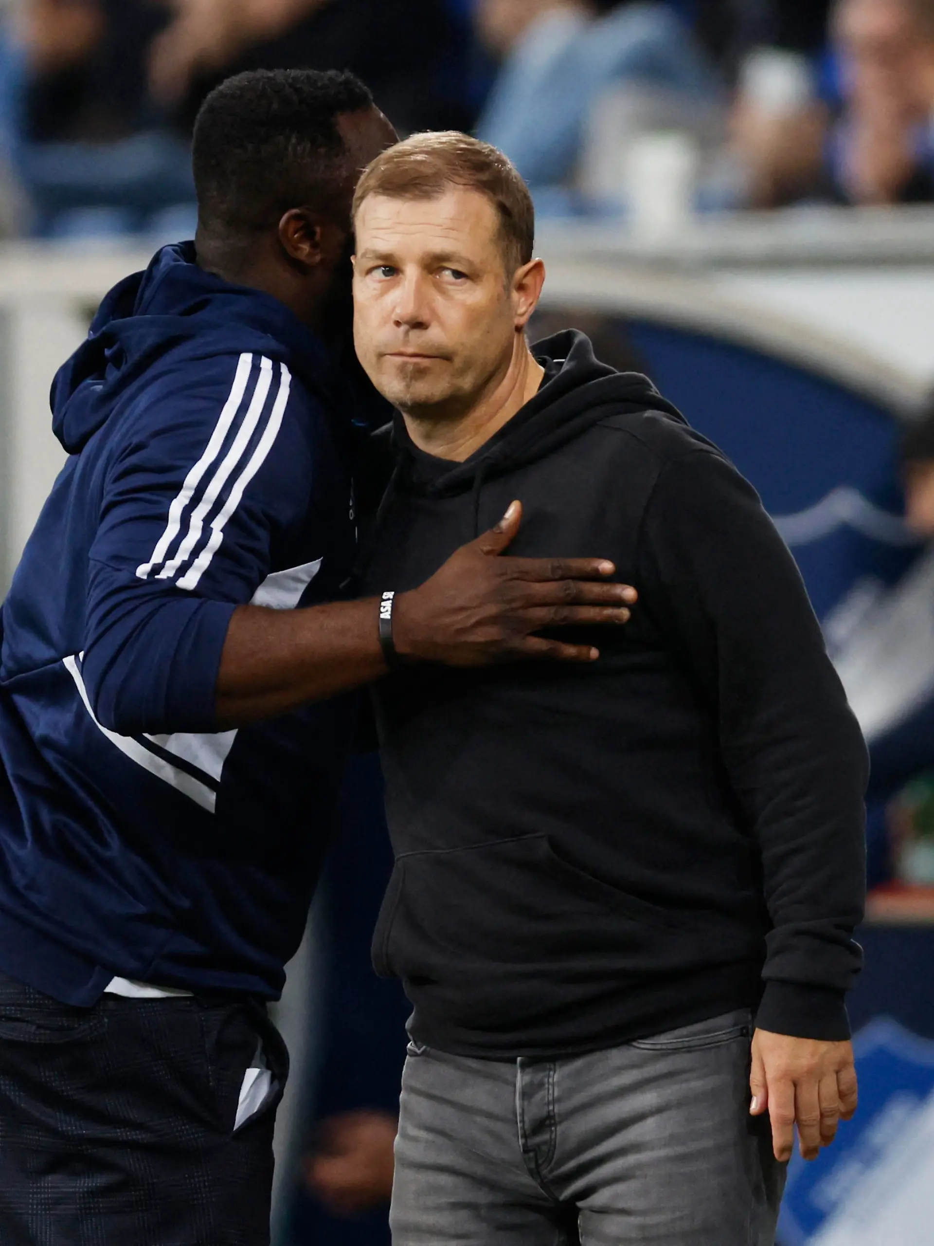 Soccer Football - DFB Cup - Second Round - TSG 1899 Hoffenheim v Schalke 04 - PreZero Arena, Sinsheim, Germany - October 18, 2022  Former Schalke 04 player Gerald Asamoah and coach Frank Kramer look dejected after the match REUTERS/Heiko Becker DFB REGULATIONS PROHIBIT ANY USE OF PHOTOGRAPHS AS IMAGE SEQUENCES AND/OR QUASI-VIDEO.