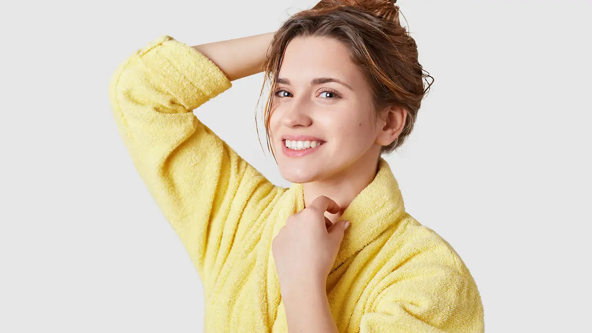 Pretty smiling girl has no make up, healthy skin, toothy smile, dressed in casual bathrobe, being in good mood after beauty treatments stands over white studio wall. Facial expressions, beauty concept Model Released Property Released xkwx facial, white, treatment, bathrobe, dry, smile, photo, one, smiling, yellow, satisfied, posing, beautiful, female, looking, pleased, natural, shampoo, portrait, healthy, long, hairdo, personality, skin, people, clean, toothy, beauty, standing, studio, alone, wash, shower, person, wet, home, spa, shot, isolated, young, bath, woman, wipe, body, expression, wellness, human, cheerful, bathroom, glad
