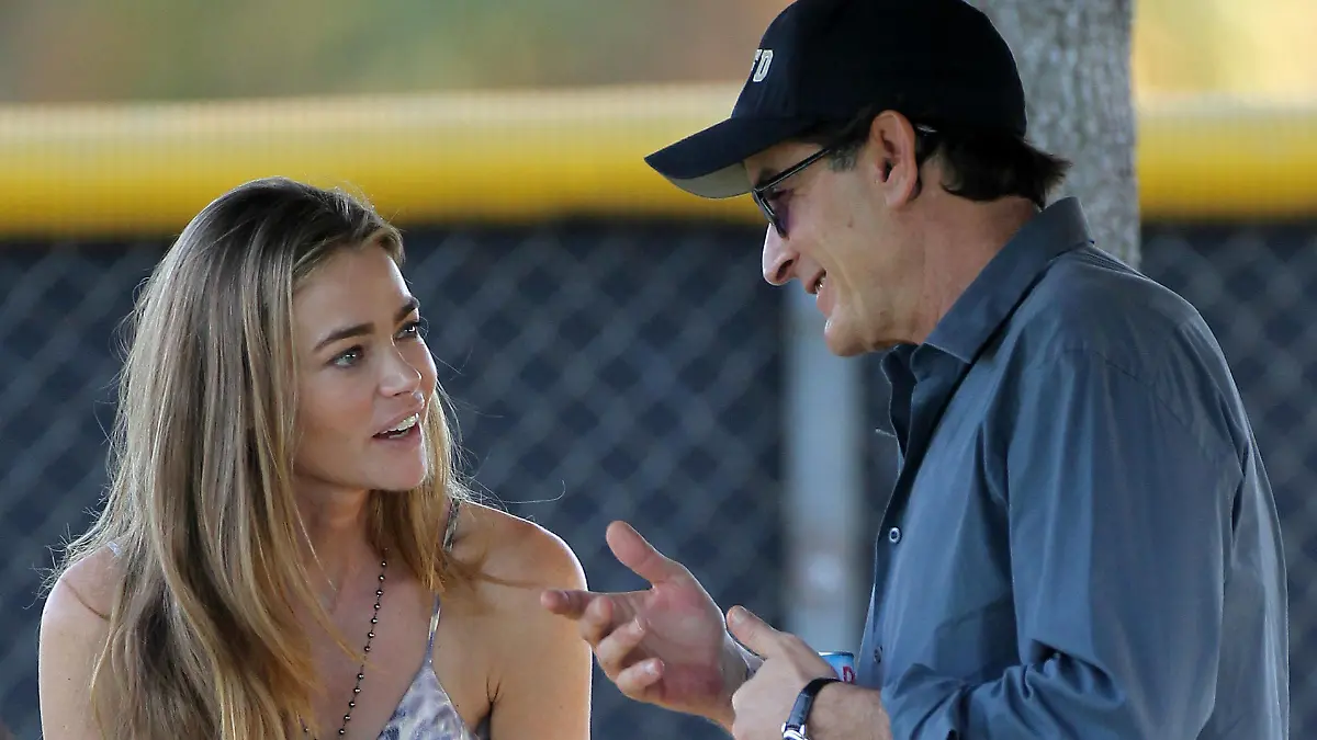 Denise Richards and friendly ex-husband Charlie Sheen spend the day together in LA watching their daughter Sam play soccer. The two ex's have been spending a lot of time together as of late, including a recent Mexican vacation. Denise was wearing a beautiful flowy summery maxi dress. The two gave each other a parting embrace before parting ways. Charlie appeared to be exuberant and happy and joked with photographers.