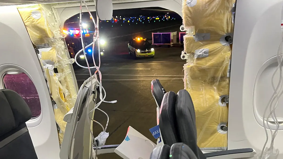 Passenger oxygen masks hang from the roof next to a missing window and a portion of a side wall of an Alaska Airlines Flight 1282, which had been bound for Ontario, California and suffered depressurization soon after departing, in Portland, Oregon, U.S., January 5, 2024 in this picture obtained from social media. Instagram/@strawberrvy via REUTERS THIS IMAGE HAS BEEN SUPPLIED BY A THIRD PARTY. MANDATORY CREDIT.