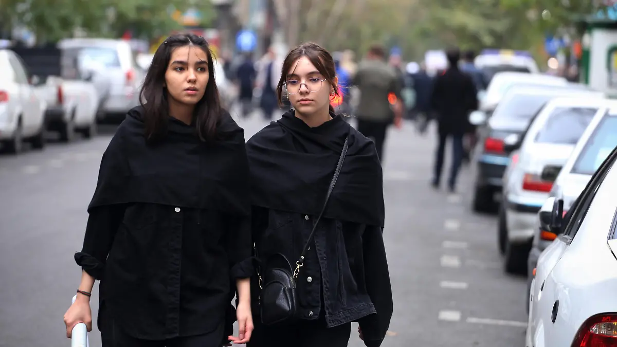 October 13, 2023, Tehran, Iran: Two Iranian schoolgirls without covering their mandatory Islamic headscarf walk at Palestine street in downtown Tehran. The Iranian government openly supported the Hamas attack on Israel and urged the Muslim community to stand by the Palestinians. Hundreds of Israelis and Palestinians have died after the militant group Hamas launched an unprecedented attack on Israel from the Gaza Strip on 07 October 2023. (Credit Image: © Rouzbeh Fouladi/ZUMA Press Wire