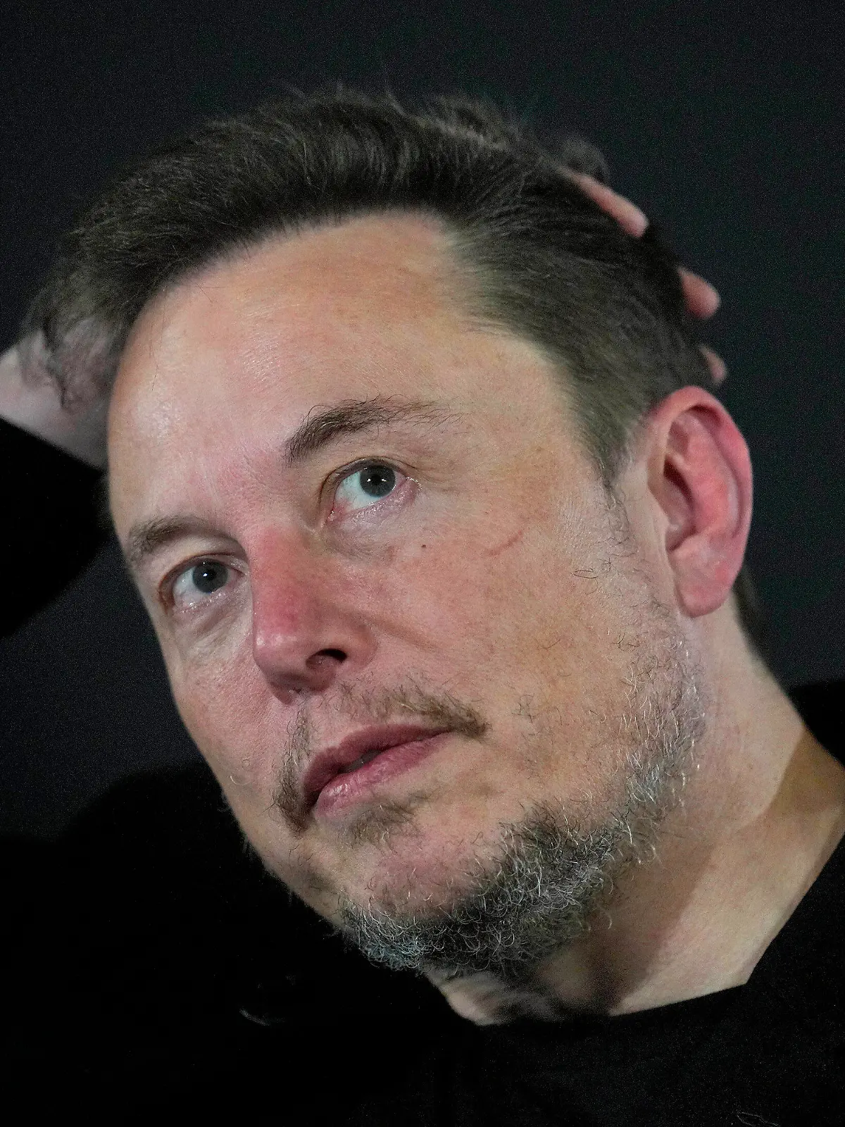 FILE - Elon Musk reacts during an in-conversation event with Britain's Prime Minister Rishi Sunak in London, on Nov. 2, 2023. A little more than a year ago, Elon Musk walked into Twitter's San Francisco headquarters, fired its CEO and other top executives and began transforming the social media platform into what's now known as X. (AP Photo/Kirsty Wigglesworth, Pool, File)