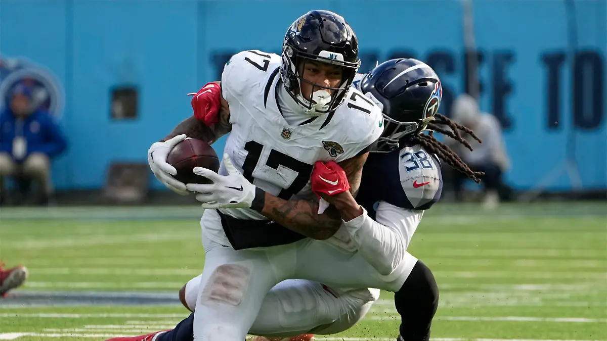 07.01.2024, USA, Nashville: American Football: Profiliga NFL, Tennessee Titans - Jacksonville Jaguars: Jacksonville Jaguars Tight End Evan Engram (17) wird nach einem Fang von Tennessee Titans Safety Terrell Edmunds (38) während der zweiten Hälfte eines NFL-Footballspiels. Foto: John Amis/FR69715 AP/AP +++ dpa-Bildfunk +++