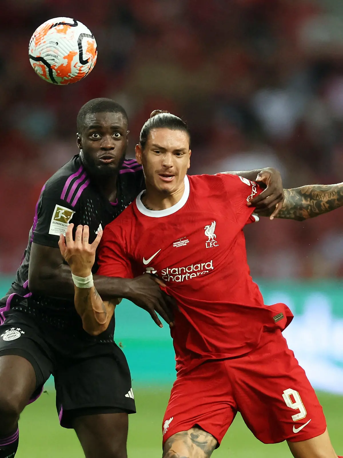 Soccer Football - Friendly - Liverpool v Bayern Munich - Singapore National Stadium, Singapore, Singapore - August 2, 2023 Liverpool's Darwin Nunez in action with Bayern Munich's Dayot Upamecano REUTERS/Edgar Su