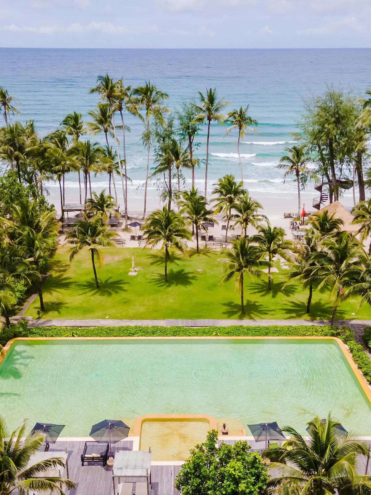 aerial drone view of a swimming pool in the jungle of Thailand, aerial view with a drone above a swimming pool in the jungle of Thailand. couple of men and women in the pool from above