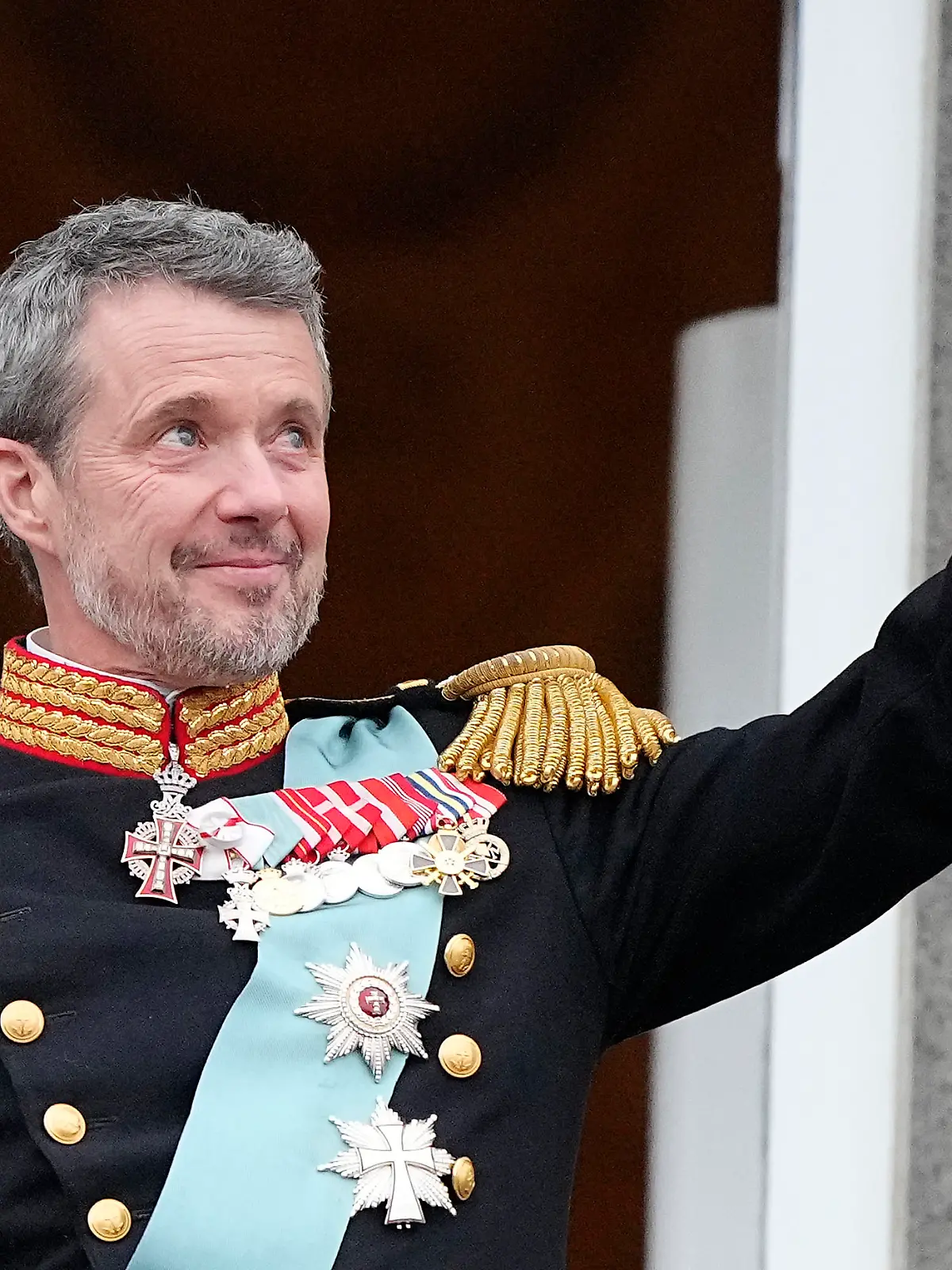 Denmark's King Frederik X waves from the balcony of Christiansborg Palace in Copenhagen, Denmark, Sunday, Jan. 14, 2024. Queen Margrethe II has become Denmark's first monarch to abdicate in nearly 900 years when she handed over the throne to her son, who has become King Frederik X. (AP Photo/Martin Meissner)