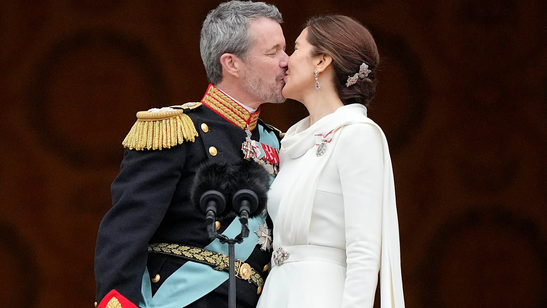Denmark's King Frederik X kisses his wife Denmark's Queen Mary on the balcony of Christiansborg Palace in Copenhagen, Denmark, Sunday, Jan. 14, 2024. Queen Margrethe II has become Denmark's first monarch to abdicate in nearly 900 years when she handed over the throne to her son, who has become King Frederik X. (AP Photo/Martin Meissner)