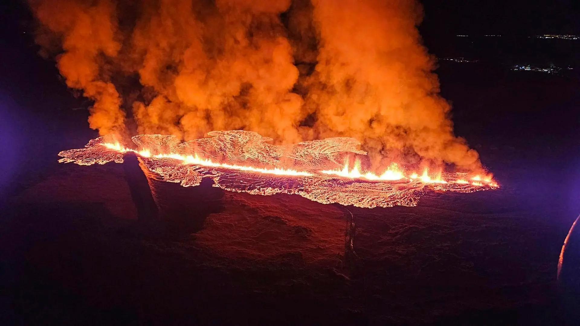 In this photo provided by Civil Protection taken from the Coast Guard's helicopter, a view of lava as the volcano erupts near Grindavík, Iceland, Sunday, Jan. 14. 2024.A volcano has erupted in southwestern Iceland, sending semi-molten rock spewing toward a nearby settlement for the second time in less than a month. Iceland's Icelandic Meteorological Office says the eruption Sunday came after a swarm of earthquakes near the town of Grindavik. (Icelandic Civil Protection via AP)
