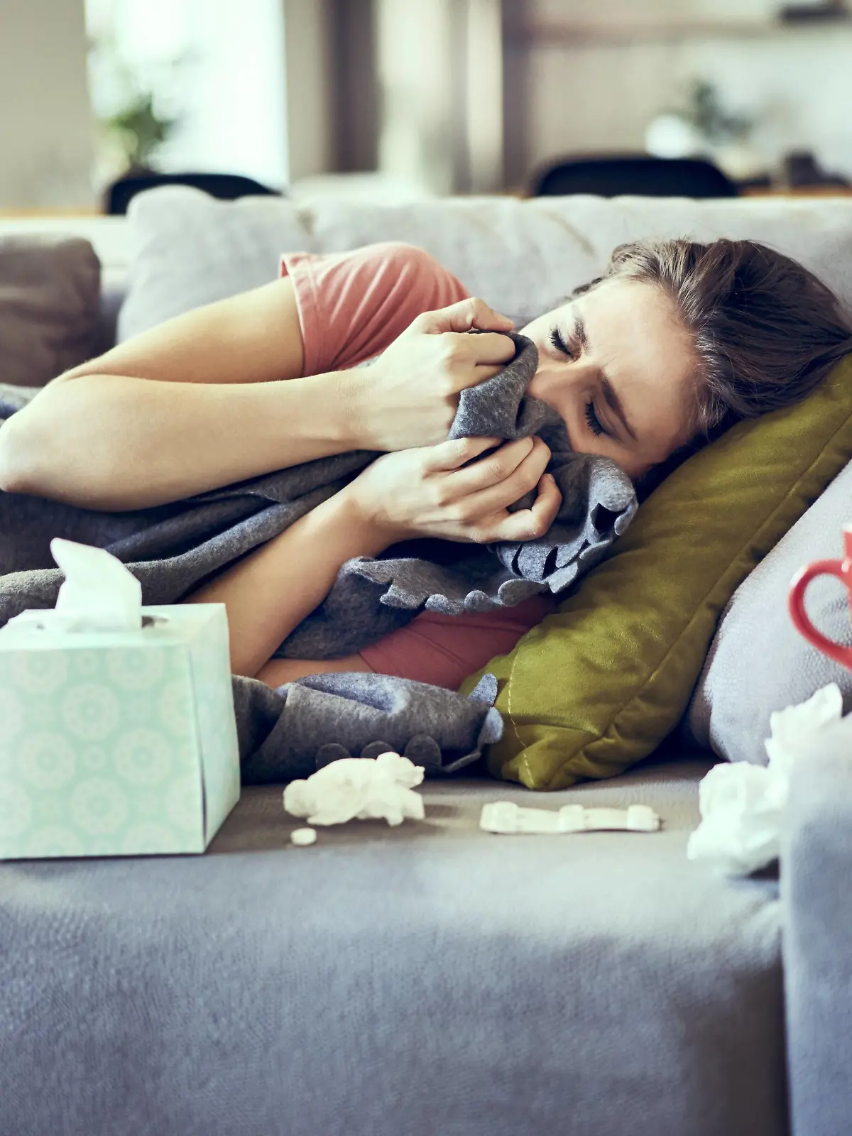 Sick woman trying to take a nap while lying on couch covered in blanket model released Symbolfoto property released PUBLICATIONxINxGERxSUIxAUTxHUNxONLY BSZF00896