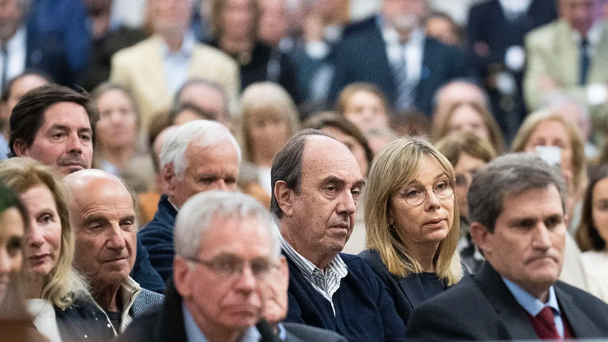 Former members of an Uruguayan rugby team who survived a 1972 plane crash in the Chilean Andes, and their relatives attend a Mass in remembrance of the accident, in Montevideo, Uruguay, Thursday, Oct. 13, 2022. The former rugby players marked the 50 anniversary of the accident where only 16 of the original 45 passengers aboard survived. (AP Photo/Matilde Campodonico)