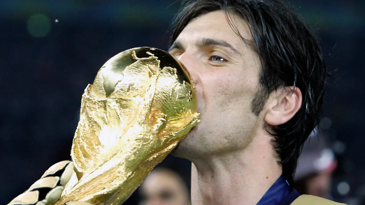 FILE - Italy's goalkeeper Gianluigi Buffon kisses the World Cup trophy after defeating France 5-3 in a penalty shootout in the final of the soccer World Cup between Italy and France in the Olympic Stadium in Berlin, Sunday, July 9, 2006. At age 45 and after a career that included a World Cup title with Italy, a long list of trophies with Juventus and many years when he was considered among the best goalkeepers in soccer, Gianluigi Buffon announced his retirement on Wednesday, Aug. 2, 2023.  (AP Photo/Thomas Kienzle)