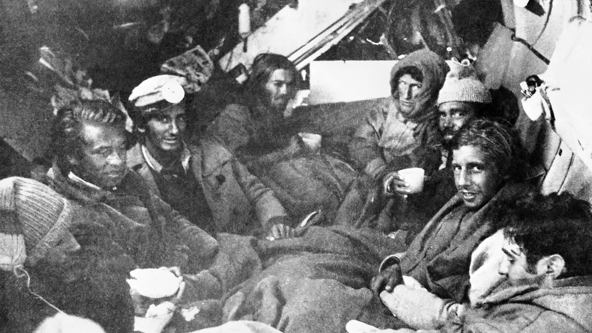 The last eight survivors of the Uruguayan Air Force plane crash in the Andes in South America, huddle together in the craft's fuselage on their final night before rescue on Dec. 22, 1972. A mountain rescue team brought them food. (AP Photo)
