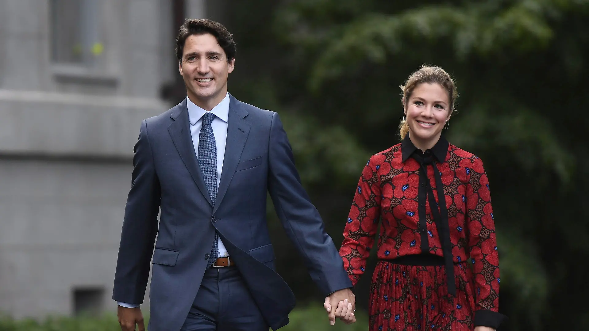 In this Wednesday, Sept. 11, 2019 photo, Canada's Prime Minister Justin Trudeau and his wife Sophie Gregoire Trudeau arrive at Rideau Hall in Ottawa, Ontario. Trudeau is quarantining himself at home after his wife exhibited flu-like symptoms. Trudeau's office said Thursday, March 12, 2020, that Sophie Grégoire Trudeau returned from a speaking engagement in Britain and had mild flu-like symptoms, including a low fever late, Wednesday night. (Justin Tang/The Canadian Press via AP)
