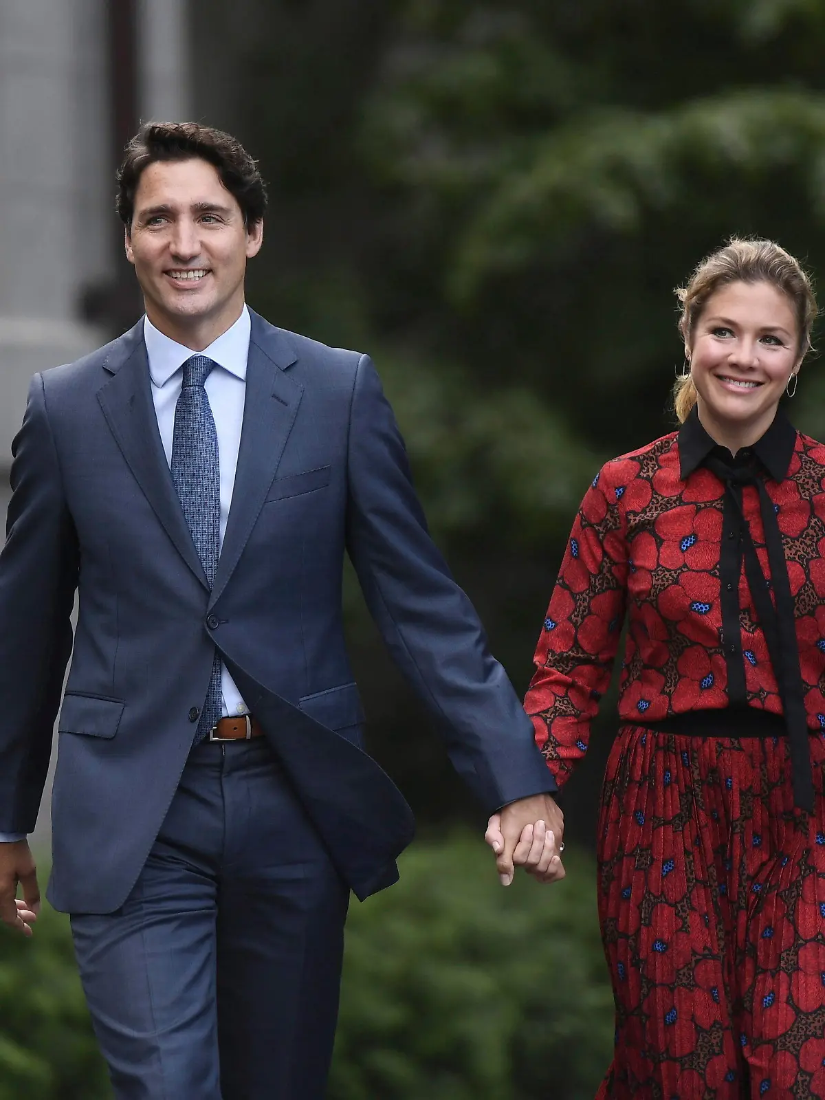 In this Wednesday, Sept. 11, 2019 photo, Canada's Prime Minister Justin Trudeau and his wife Sophie Gregoire Trudeau arrive at Rideau Hall in Ottawa, Ontario. Trudeau is quarantining himself at home after his wife exhibited flu-like symptoms. Trudeau's office said Thursday, March 12, 2020, that Sophie Grégoire Trudeau returned from a speaking engagement in Britain and had mild flu-like symptoms, including a low fever late, Wednesday night.  (Justin Tang/The Canadian Press via AP)