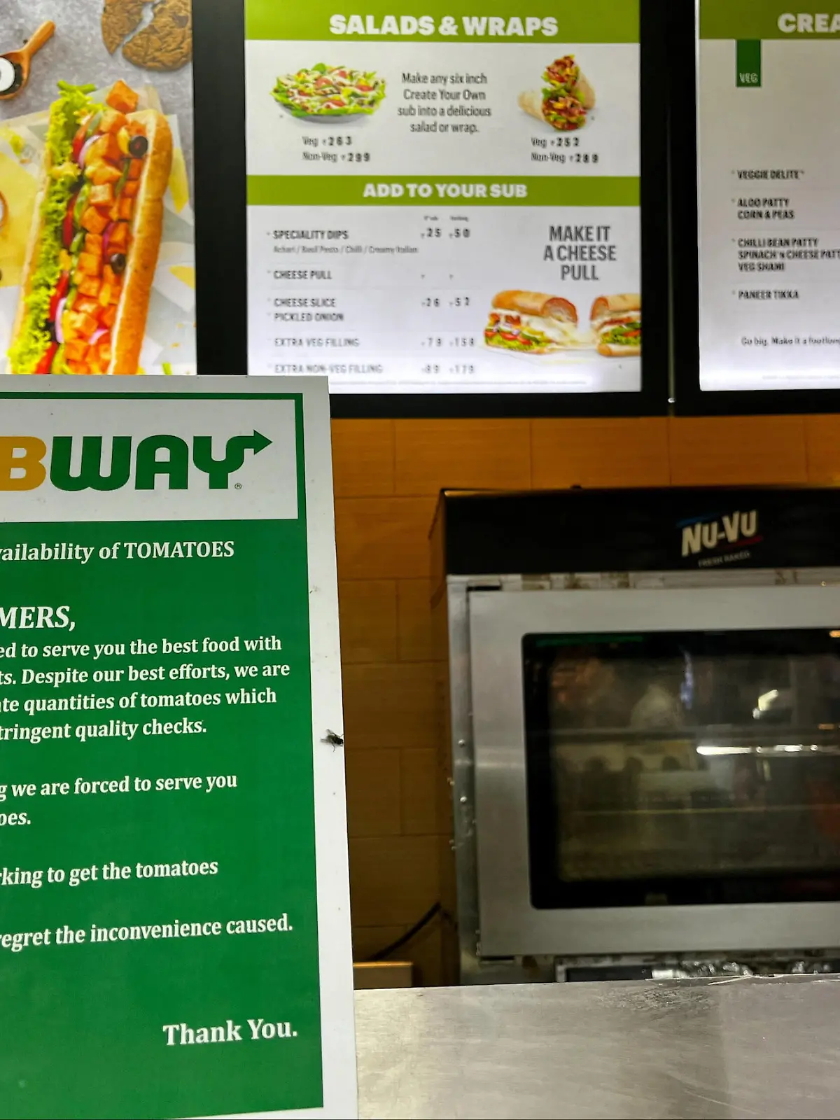 A notice on the temporary unavailability of tomatoes is seen at a Subway outlet at an airport terminal in New Delhi, India, July 22, 2023. REUTERS/Krishn Kaushik