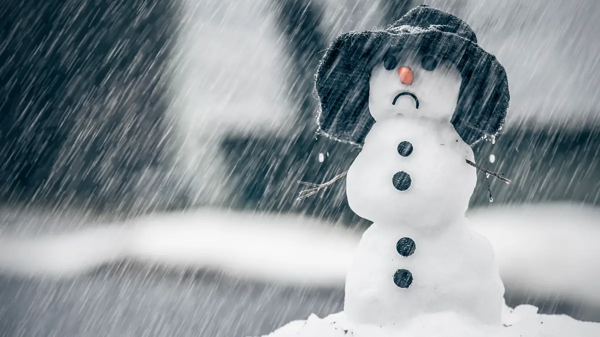 Melting snowman on the warm rainy day in the middle of January winter weather anomalies.