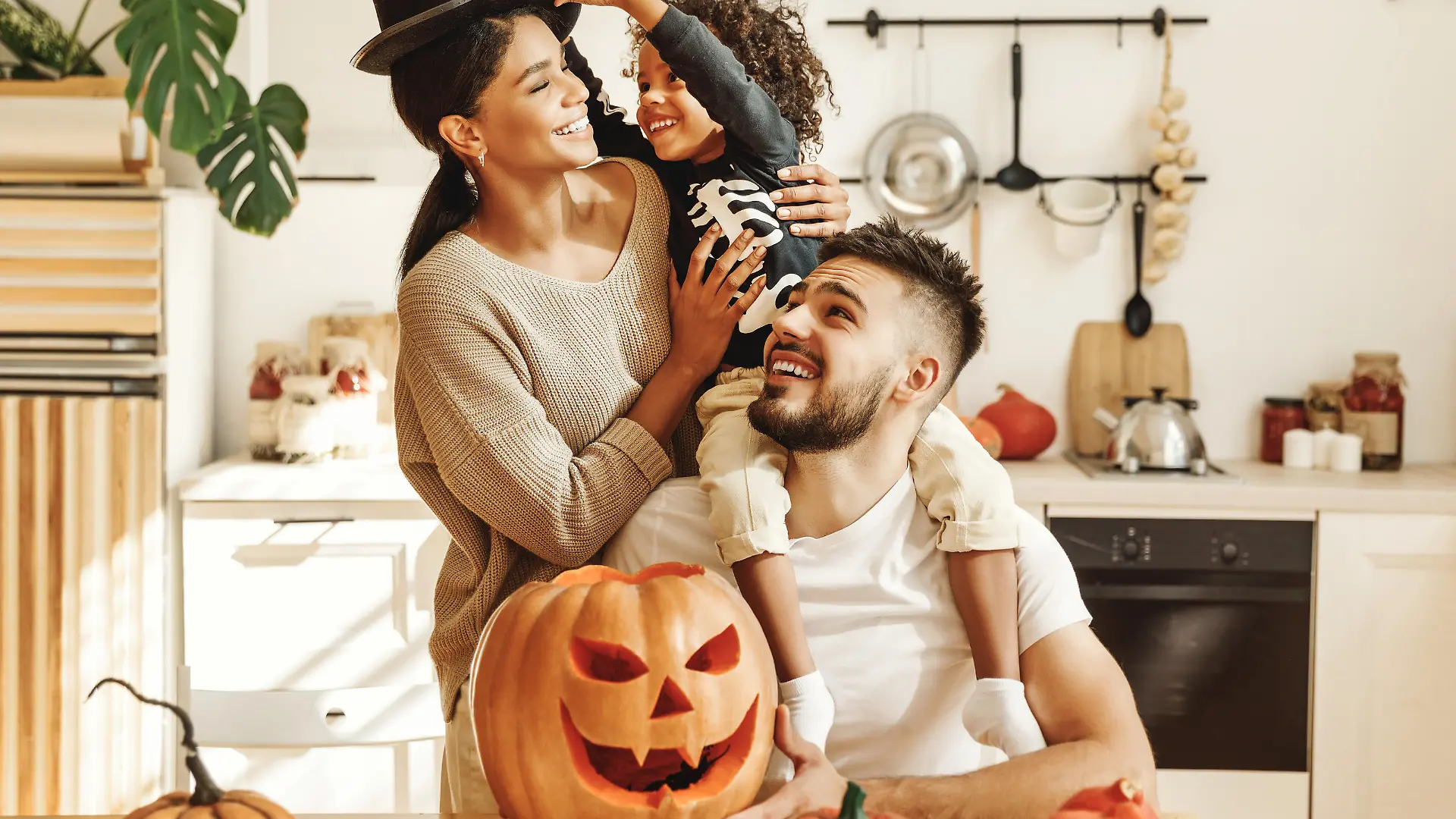 happy multiethnic family mother, father and little son have fun and celebrate Halloween at home