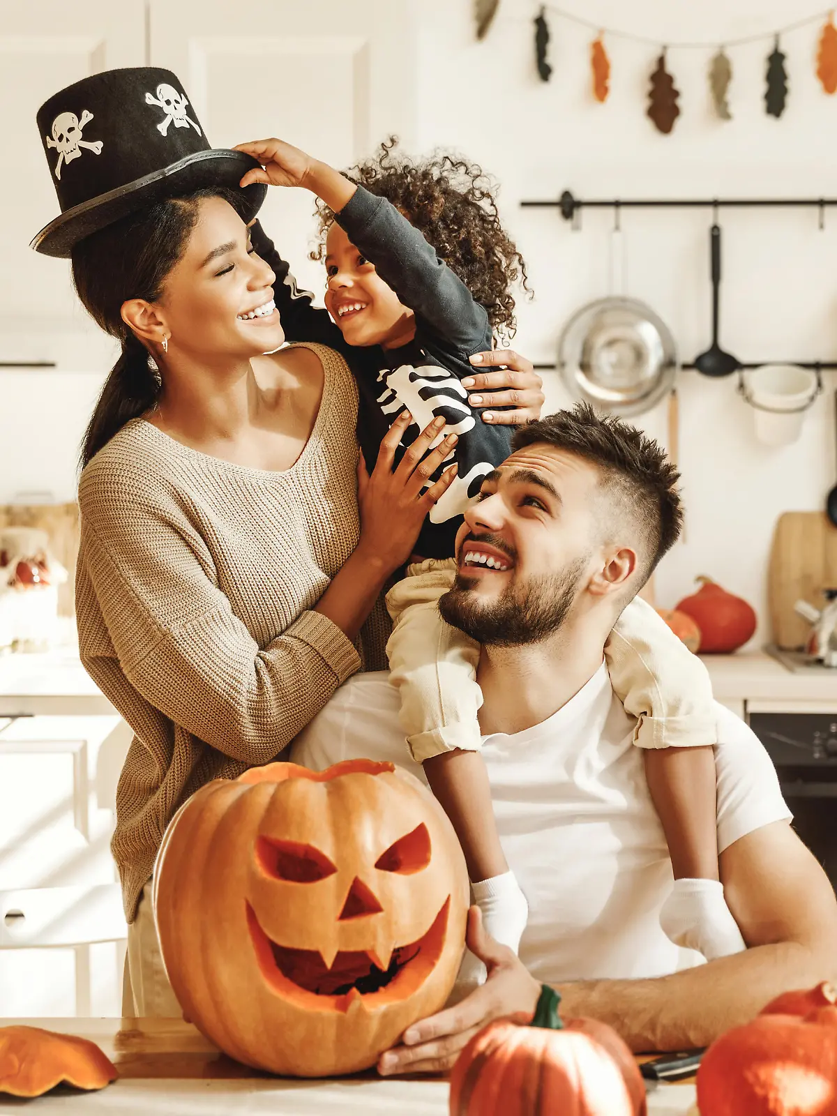 happy multiethnic family mother, father and little son have fun and celebrate Halloween at home