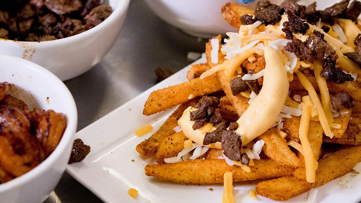 October 16, 2019, Temecula, California, USA: Culinary student Spencer Paredes meticulously garnishes steak onto a surf 'n turf fries dish during a demonstration at Temecula Valley High School in Temecula on Wednesday, Oct. 16, 2019. The culinary students will team with Pechanga chefs to compete for best loaded fries at the 2019 Battle of the Burgers competition at Pechanga Resort Casino this Saturday. (Credit Image: © Watchara Phomicinda/Orange County Register via ZUMA Wire