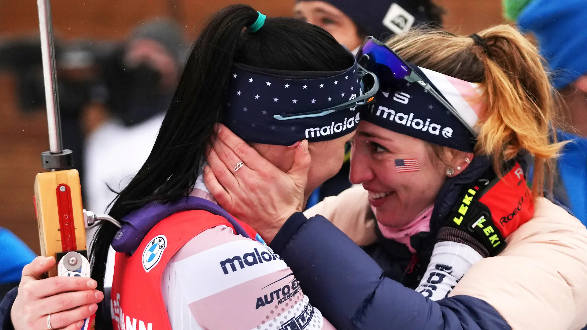 FILE - Joanne Reid, left, of United States, and compatriot Deedra Irwin embrace at the finish line during the women's 4 x 6 km relay race at the biathlon World Cup in Anterselva, Italy, Jan. 22, 2022. The United States Biathlon national champion was sexually harassed and abused for years by a ski-wax technician while racing on the sport's elite World Cup circuit, investigators found. When the two-time Olympian complained, Reid said she was told his behavior was just part of the male European culture. (AP Photo/Matthias Schrader)