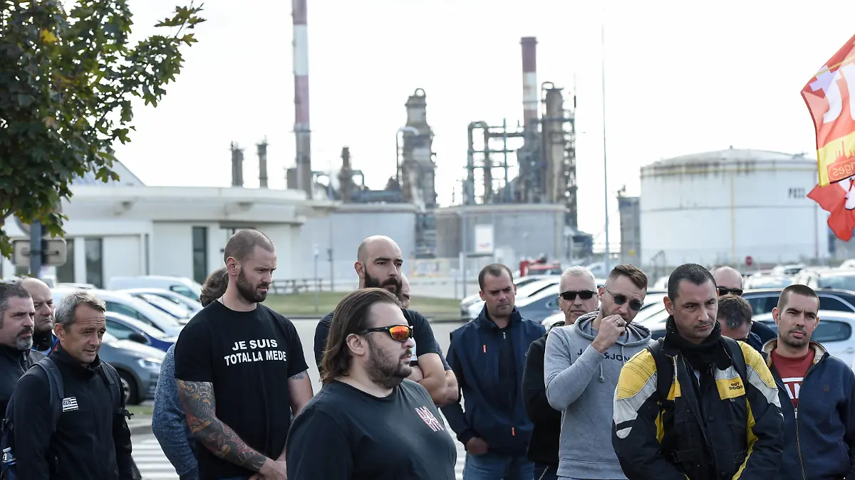 Trade unionists and striking employees gather outside the TotalEnergies refinery site, in Donges, western France, on October 12, 2022. France's Prime Minister announced on October 11, 2022 the requisition of staff to unlock the fuel depots of the group Esso-Exxonmobil, where a wage agreement was reached on October 10, 2022 by two trade unions, which have a majority at the group but not at its refineries.//SALOM-GOMIS_d010/2210121532/Credit:Sebastien SALOM-GOMIS/SIPA/2210121541