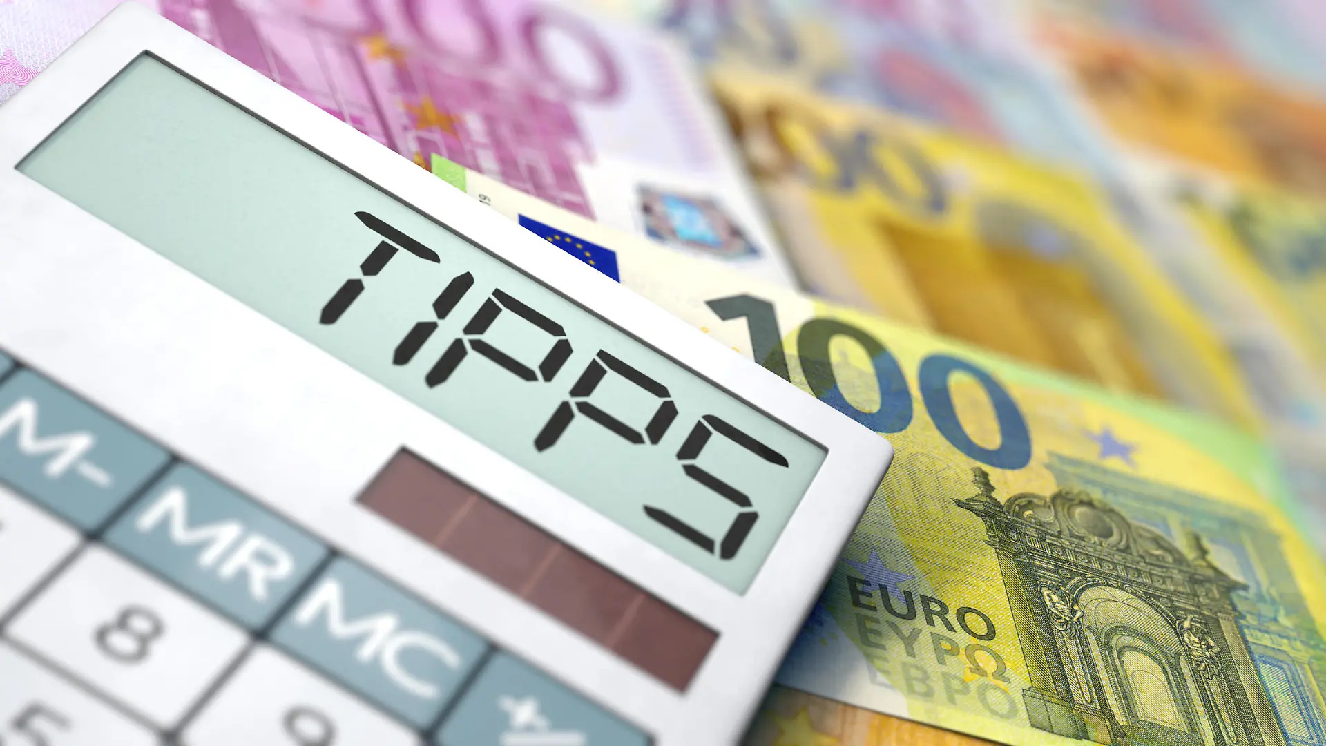 Finance tips - Calculator lies on Euro banknotes.