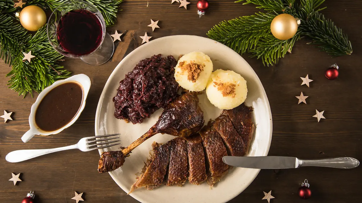 ILLUSTRATION - Ein Stueck Weihnachtsgans wird am 11.12.2021 in Wittenberge mit Knoedeln und Rotkohl auf einem Teller serviert (gestellte Szene). Foto: Christin Klose
