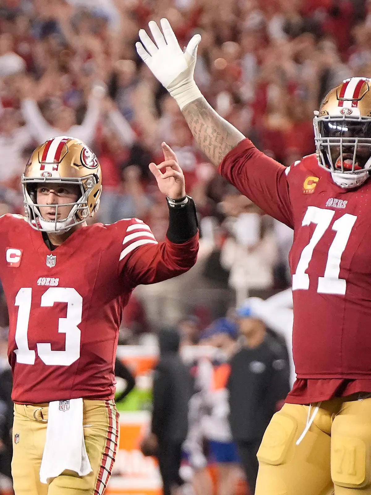 San Francisco 49ers quarterback Brock Purdy (13) and offensive tackle Trent Williams (71) celebrate after a touchdown run by Elijah Mitchell during the second half of the NFC Championship NFL football game against the Detroit Lions in Santa Clara, Calif., Sunday, Jan. 28, 2024. (AP Photo/Mark J. Terrill)