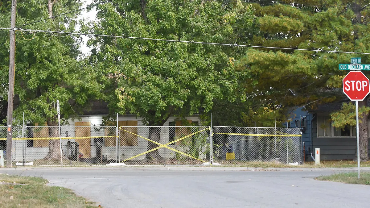 Police tape blocks off the Excelsior Springs residence of Timothy M. Haslett Jr., after the home was boarded up and fenced off Monday, Oct. 10, 2022, in Excelsior Springs, Mo., following a days-long execution of a search warrant at the home. Haslett was arrested Friday, Oct. 7, 2022, and is charged with first-degree rape or attempted rape, first-degree kidnapping and second-degree assault. (Bill Lukitsch/The Kansas City Star via AP)