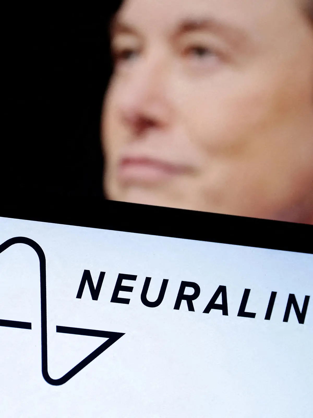 FILE PHOTO: Neuralink logo and Elon Musk photo are seen in this illustration taken, December 19, 2022. REUTERS/Dado Ruvic/Illustration/File Photo