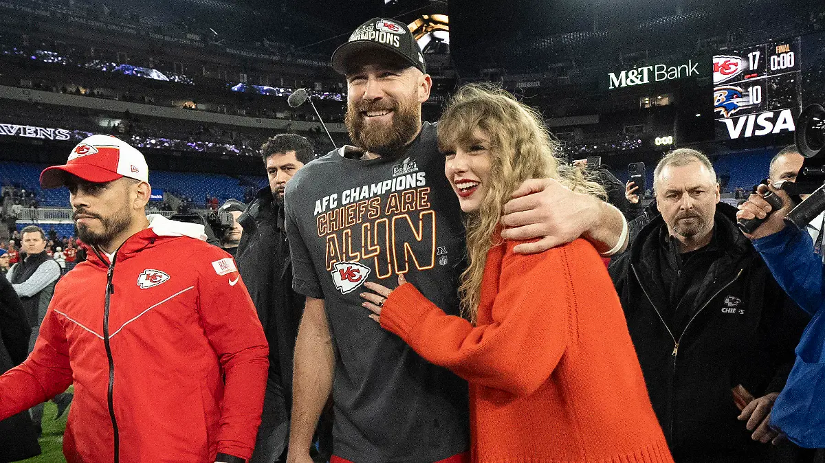 FILE - Kansas City Chiefs tight end Travis Kelce walks with Taylor Swift following the AFC Championship NFL football game between the Baltimore Ravens and the Kansas City Chiefs, Sunday, Jan. 28, 2024, in Baltimore. As the Kansas City Chiefs head to the Super Bowl, baseless conspiracy theories are spreading on social media suggesting that the romance between megastar Taylor Swift and Kansas City Chiefs tight end Travis Kelce is part of a secret plot to help President Joe Biden get reelected in 2024. (AP Photo/Julio Cortez, File)