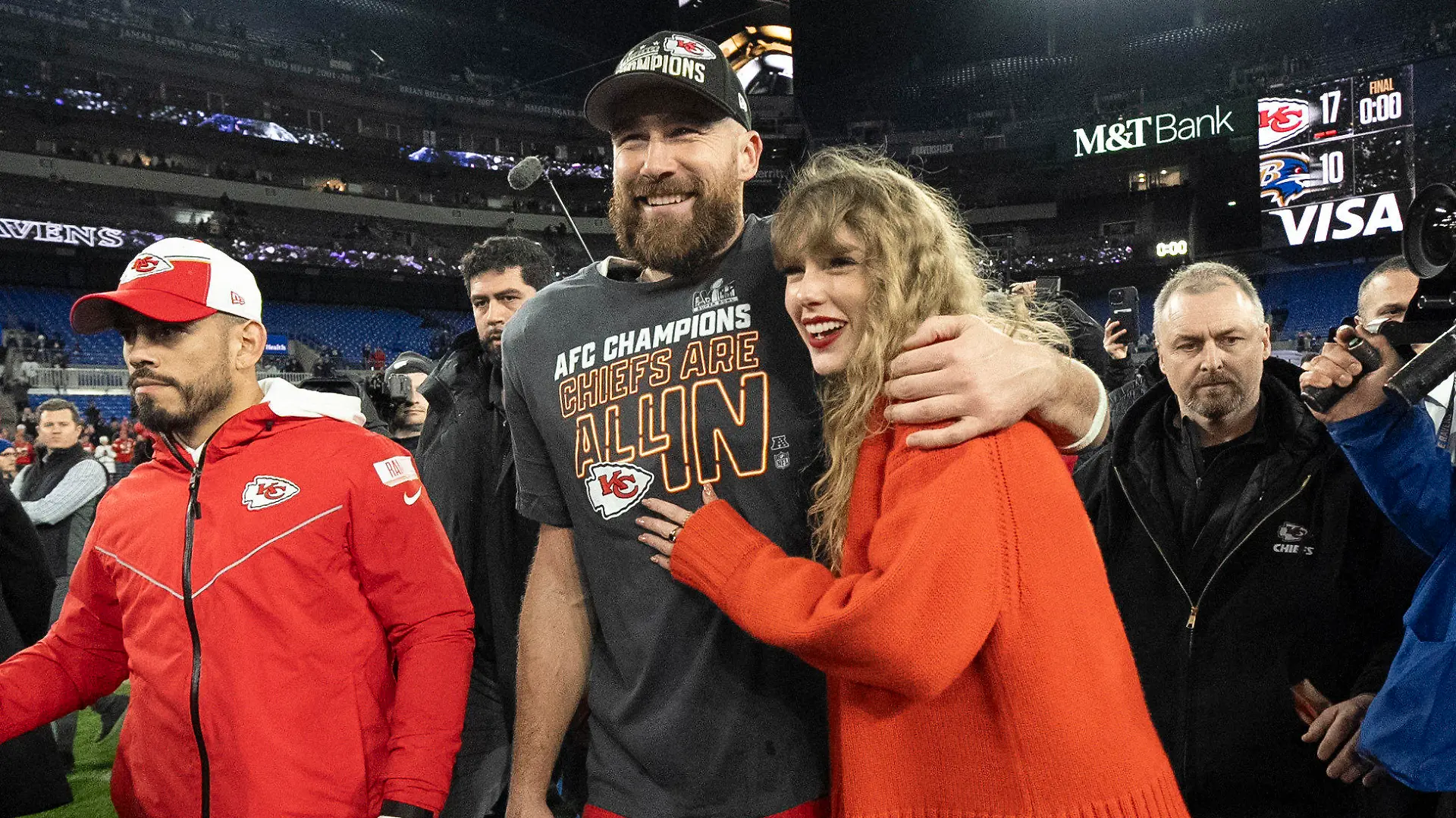 FILE - Kansas City Chiefs tight end Travis Kelce walks with Taylor Swift following the AFC Championship NFL football game between the Baltimore Ravens and the Kansas City Chiefs, Sunday, Jan. 28, 2024, in Baltimore. As the Kansas City Chiefs head to the Super Bowl, baseless conspiracy theories are spreading on social media suggesting that the romance between megastar Taylor Swift and Kansas City Chiefs tight end Travis Kelce is part of a secret plot to help President Joe Biden get reelected in 2024. (AP Photo/Julio Cortez, File)