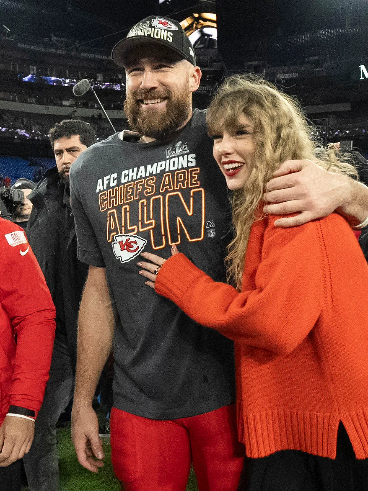 FILE - Kansas City Chiefs tight end Travis Kelce walks with Taylor Swift following the AFC Championship NFL football game between the Baltimore Ravens and the Kansas City Chiefs, Sunday, Jan. 28, 2024, in Baltimore. As the Kansas City Chiefs head to the Super Bowl, baseless conspiracy theories are spreading on social media suggesting that the romance between megastar Taylor Swift and Kansas City Chiefs tight end Travis Kelce is part of a secret plot to help President Joe Biden get reelected in 2024. (AP Photo/Julio Cortez, File)