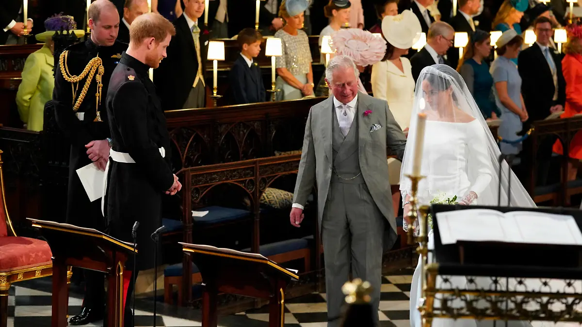 Prince Harry looks at his bride, Meghan Markle, as she arrives accompanied by the Prince of Wales in St George's Chapel at Windsor Castle for their wedding.