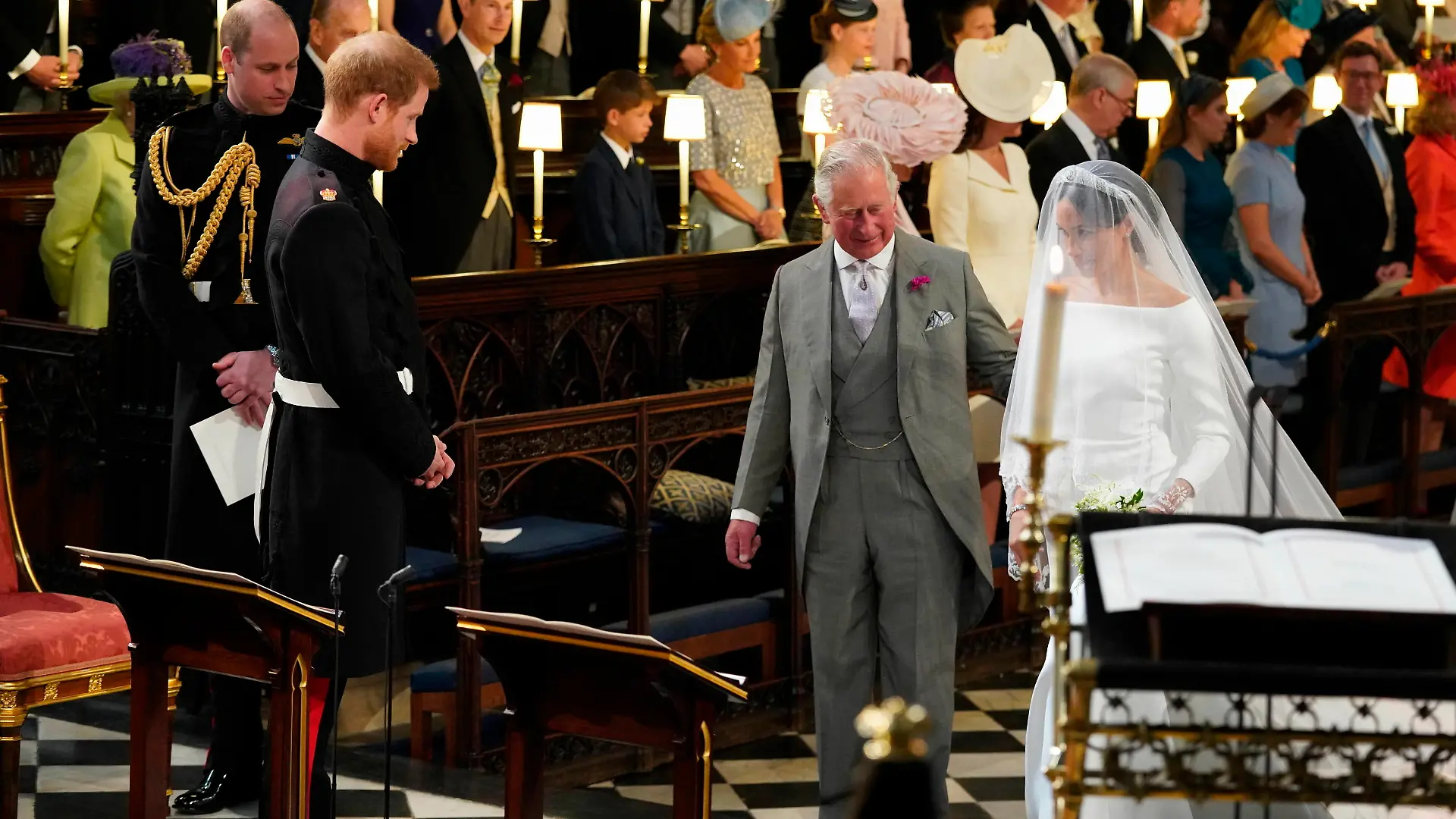 Prince Harry looks at his bride, Meghan Markle, as she arrives accompanied by the Prince of Wales in St George's Chapel at Windsor Castle for their wedding.