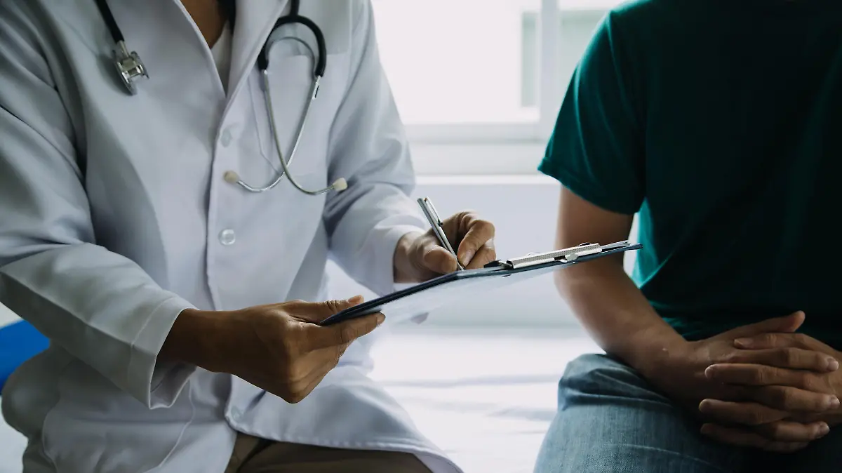 Male patient having consultation with doctor or psychiatrist who working on diagnostic examination on men's health disease or mental illness in medical clinic or hospital mental health service center