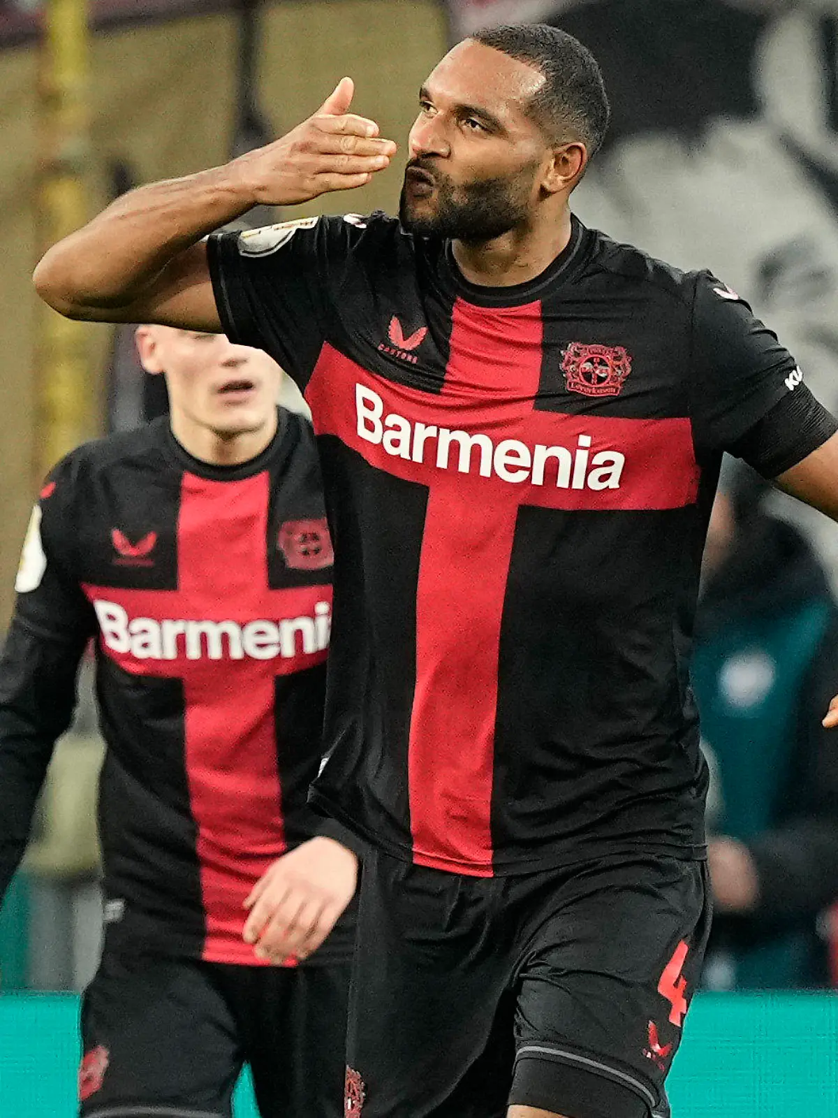 Leverkusen's Jonathan Tah celebrates after scoring his side's third goal during the German soccer cup quarterfinal match between Bayer 04 Leverkusen and VfB Stuttgart at the BayArena in Leverkusen, Germany, Tuesday, Feb. 6, 2024. (AP Photo/Martin Meissner)
