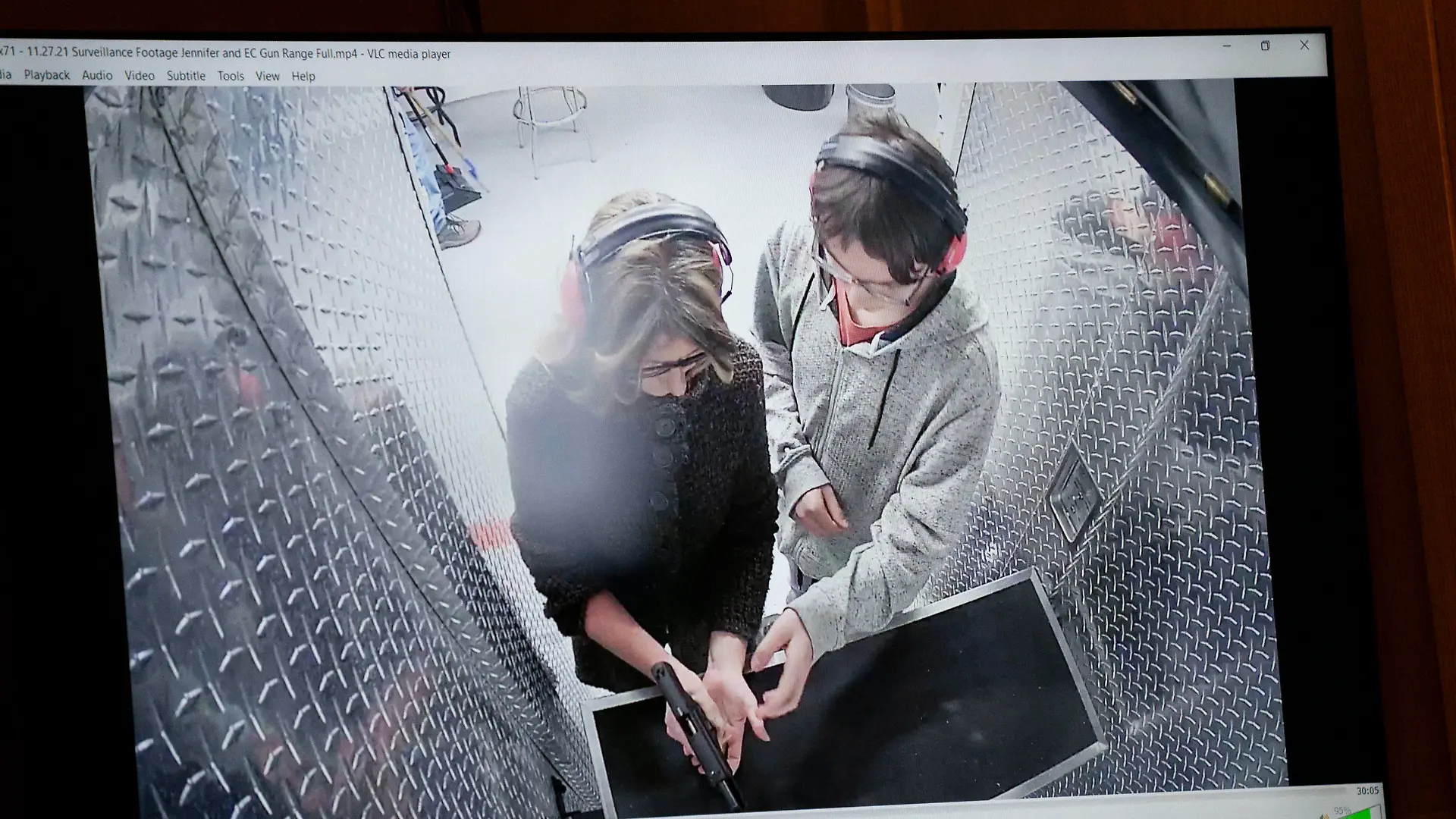 Video showing Jennifer Crumbley, left, with her son Ethan Crumbley at a gun range on Nov. 27, 2021 for target practice, is shown in the courtroom during Jennifer Crumbley's trial, Thursday, Jan. 25, 2024, in Pontiac, Mich. Jennifer Crumbley is charged with involuntary manslaughter in the Nov. 30, 2021, attack at Oxford High School. Prosecutors say she and husband James Crumbley were grossly negligent and that their son's actions were foreseeable. (Mandi Wright/Detroit Free Press via AP, Pool)