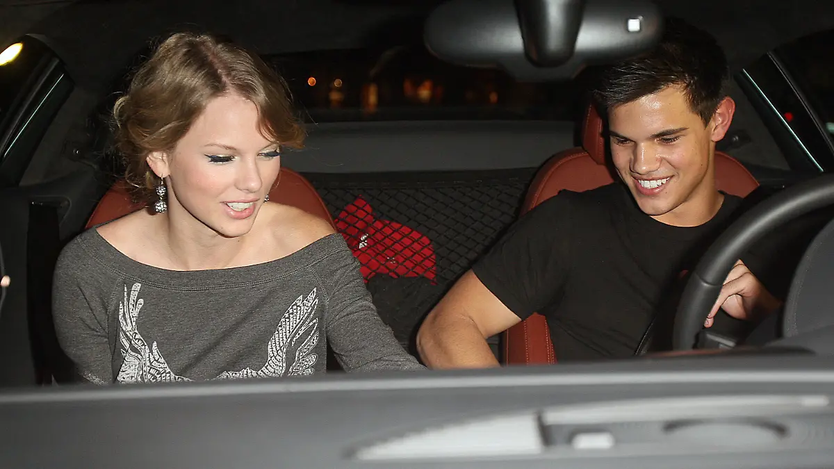 Young Hollywood couple Taylor Swift and Taylor Lautner leaving the Chris Steakhouse restaurant in Beverly Hills, CA with take out food bag.