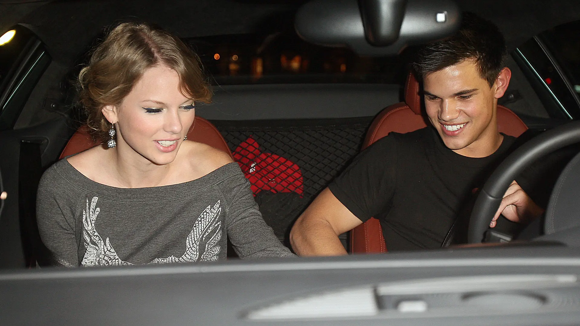 Young Hollywood couple Taylor Swift and Taylor Lautner leaving the Chris Steakhouse restaurant in Beverly Hills, CA with take out food bag.