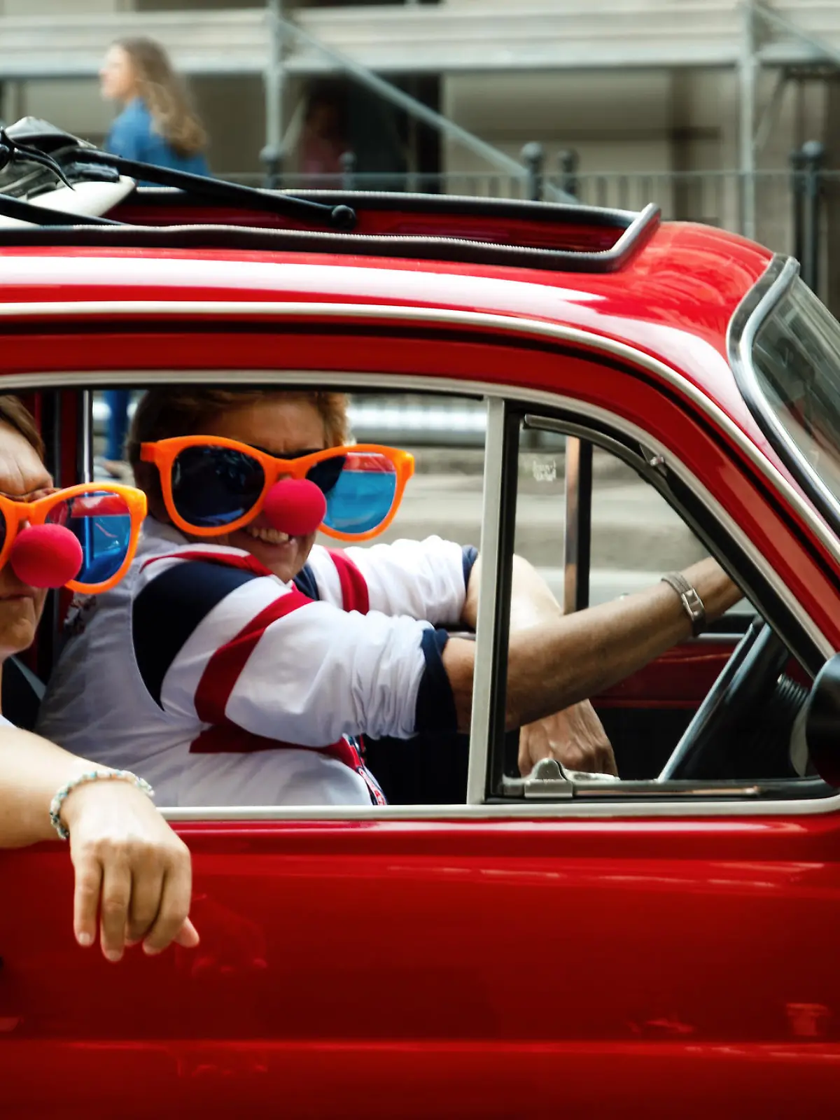 Turin, Italy - September 24, 2017 - Funny looking couple driving an old red Fiat 500 during a classic car rally in Turin (Italy) on september 24, 2017